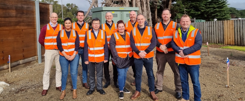 Members of the Pacific Blue executive team in orange vests.