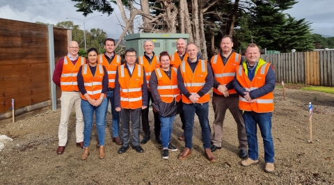 Members of the Pacific Blue executive team in orange vests.